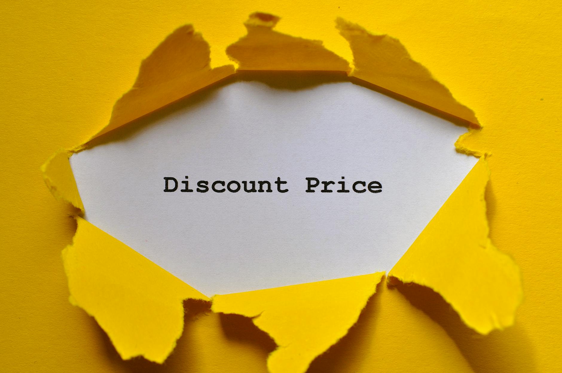 torn yellow paper revealing discount price